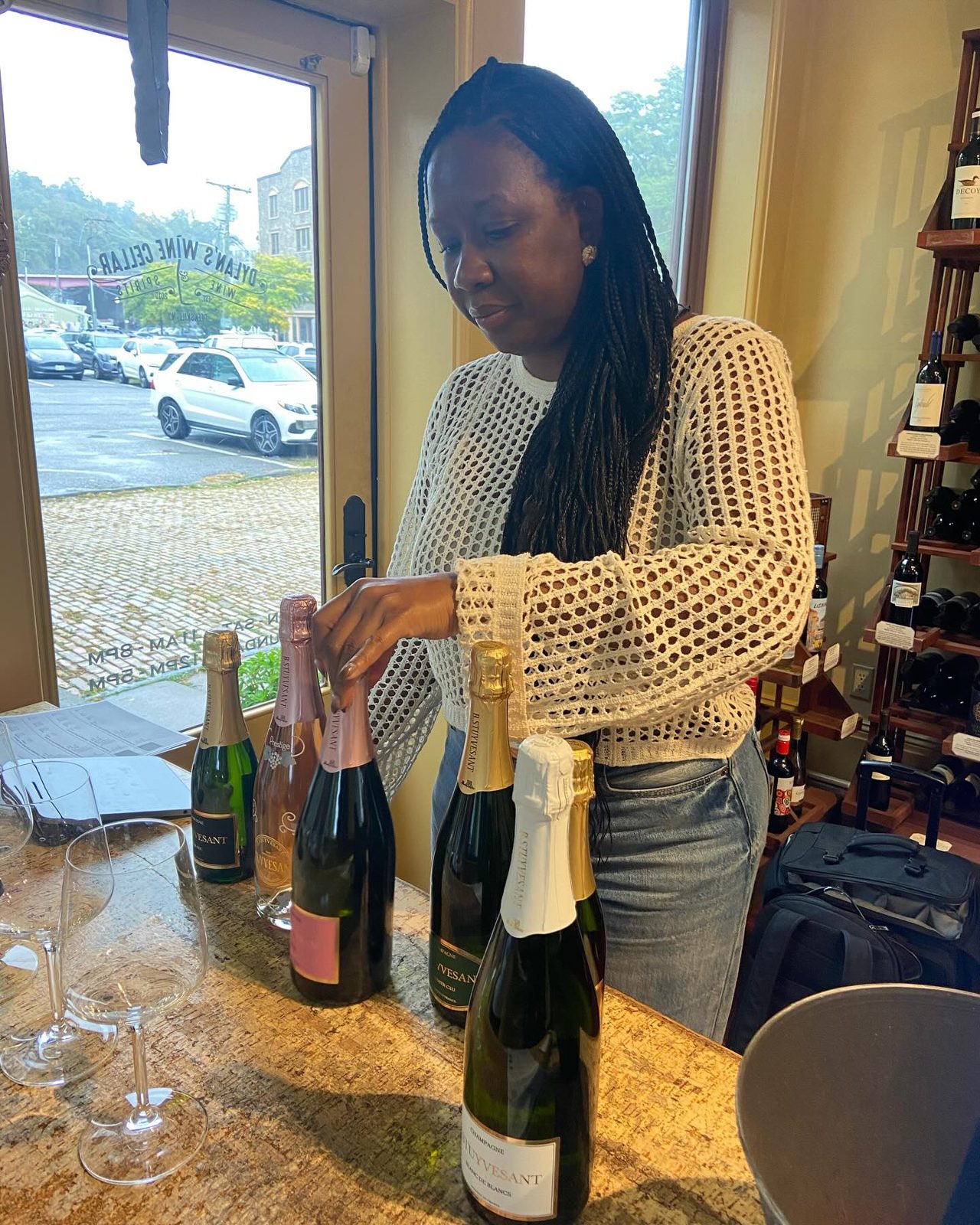 A staff member opening a bottle of Champagne